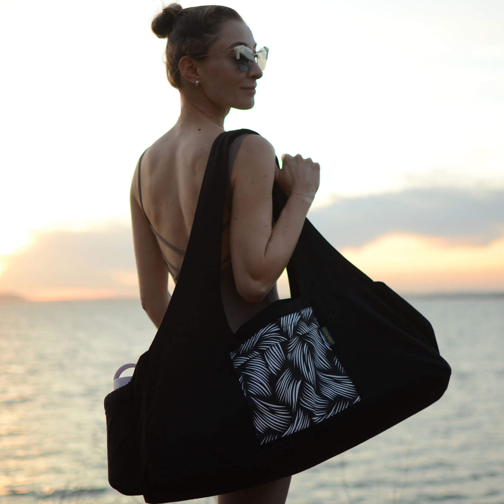 Woman Carrying the Fitness Mad Yoga Kit Bag with Water Bottle Holder - Black